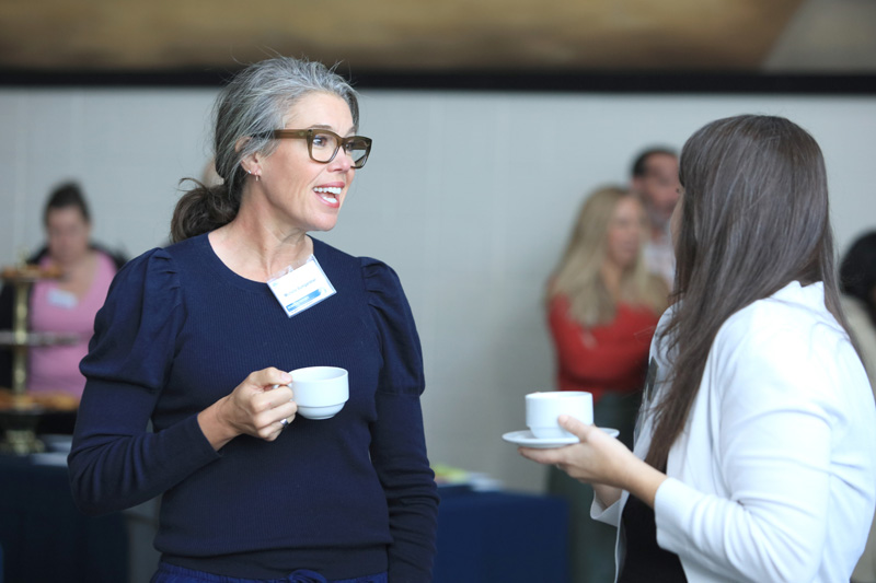 Two Community Breakfast attendees talking