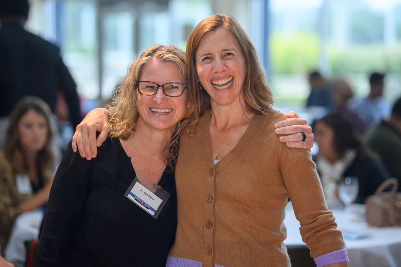 Two Breakfast attendees smiling