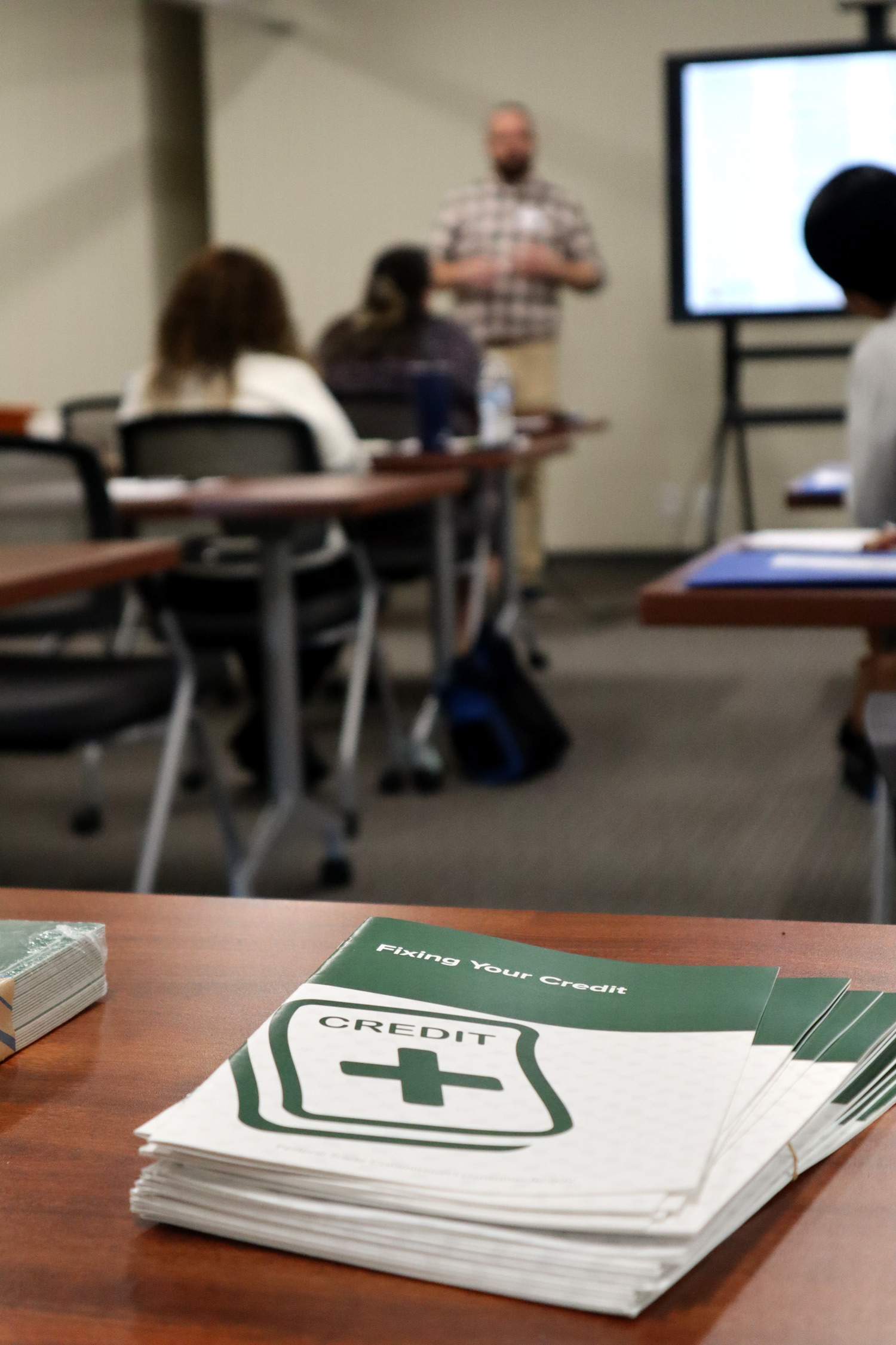 Credit pamphlet and class in background