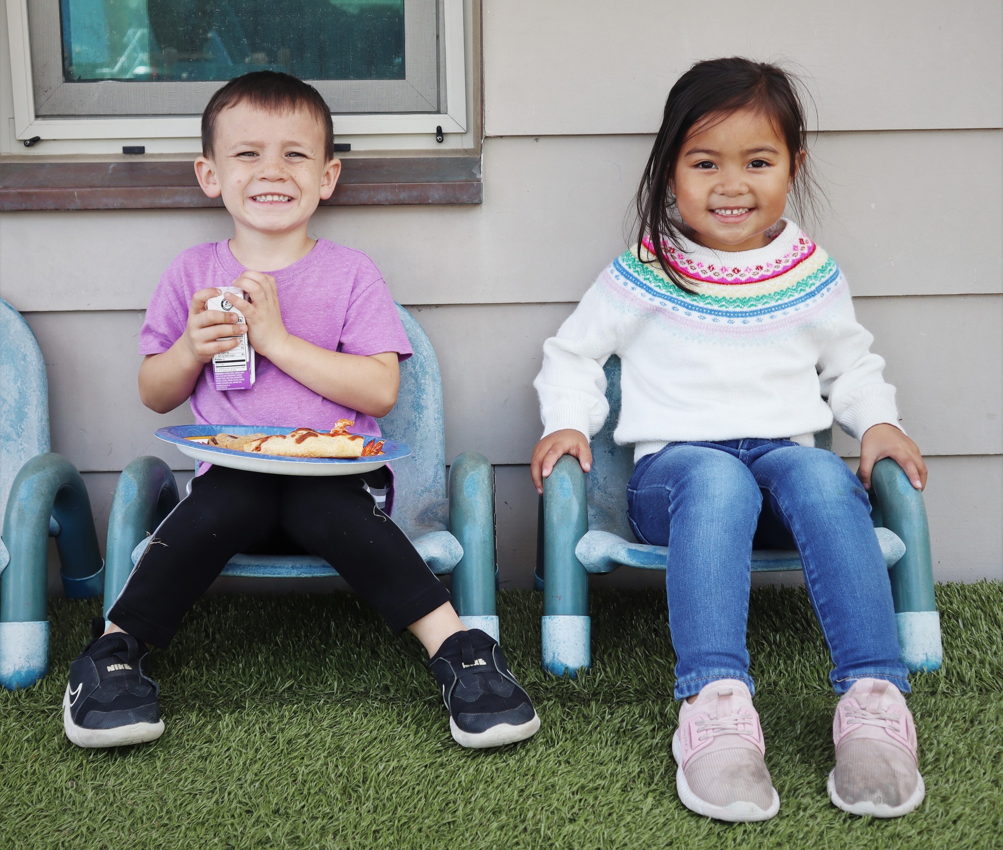 Two kids sitting in chairs