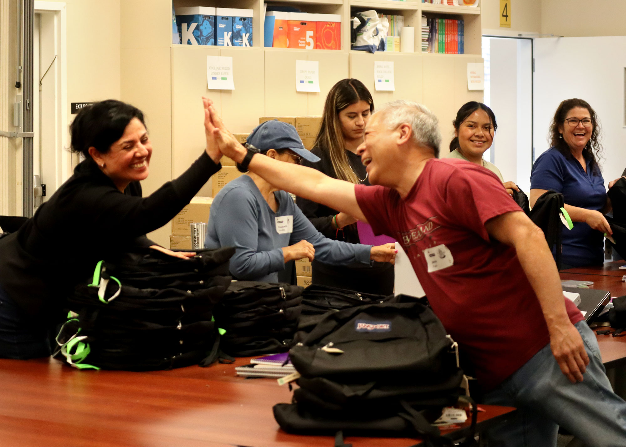Two volunteers high fiving